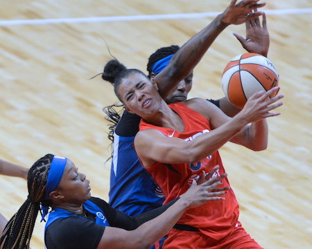 Washington Mystics point guard Natasha Cloud absorbs contact on a drive to the basket during the Mystics' 101-78 win over the Minnesota Lynx at Entertainment and Sports Arena in D.C. on Sunday, Aug. 11. (John E. De Freitas/The Washington Informer)