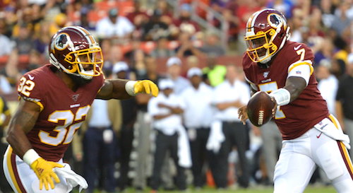 Washington Redskins quarterback Dwayne Haskins hands the ball off to running back Samaje Perine during Washington's 20-7 preseason loss to the Baltimore Ravens at FedEx Field in Landover, Md., on Aug. 29. (John E. De Freitas/The Washington Informer)
