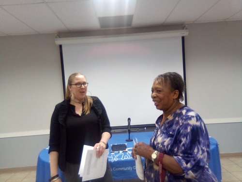 Kate Mereand-Sinha of the D.C. Department of Small & Local Business Development chats with Ward 7 business owner Evie Washington. (James Wright/The Washington Informer)