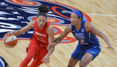 Washington Mystics forward Aerial Powers drives against Minnesota Lynx forward Napheesa Collier during the Mystics' 101-78 win at Entertainment and Sports Arena in D.C. on Aug. 11. (John E. De Freitas/The Washington Informer)