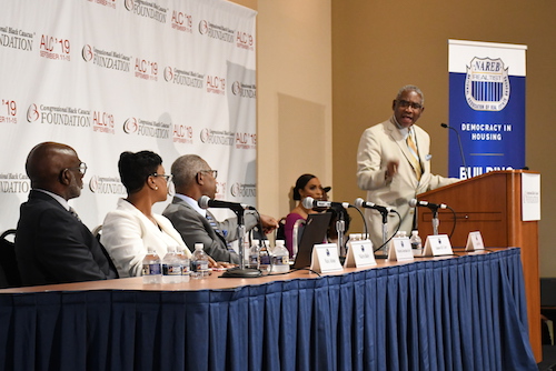Rep. Gregory Meeks (D-N.Y.) speaks at the State of Housing in Black America issue forum while panelists Maurice Jourdain-Earl, Nikitra Bailey and Mark Alston look on. (Roy Lewis/The Washington Informer)