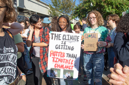 Samia Abdur-Rahim (center), a 10th grader at Northwood High School in Silver Spring, Maryland, linked with other students and walked out of class Sept. 20 to protest climate change. (Shevry Lassiter/The Washington Informer)