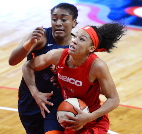 Washington Mystics guard Aerial Powers attempts to drive past Connecticut Sun forward Morgan Tuck in the first half of the Mystics' 95-86 victory in Game 1 of the WNBA finals at Entertainment and Sports Arena in southeast D.C. on Sept. 29. (John E. De Freitas/The Washington Informer)