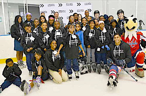 David L. Cohen, senior executive vice president and chief diversity officer of Comcast Corporation joins in a group shot at the Internet Essentials fall tour at Fort Dupont Ice Skating Rink in southeast D.C. on Sept. 10. (Anthony Tilghman/The Washington Informer)
