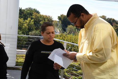 Melanee Woodard, AVP, Marketing Manager at Industrial Bank, engages residents at the launch of Financially Fit DC. (Roy Lewis/The Washington Informer)
