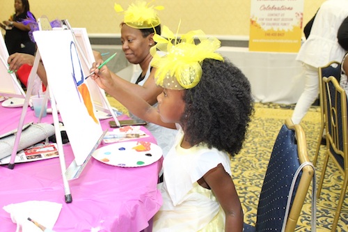 EmauniJ Manley (foreground) paints a butterfly with her mother, Rosalynd Manley, at the "Girls Talk: Love United" Mother Daughter Tea at Camelot by Martin's in Upper Marlboro on Sept. 28. (Brigette Squire/The Washington Informer)