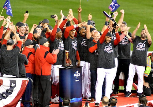 Washington Nationals manager Dave Martinez raises the trophy and celebrates with his team after sweeping the St. Louis Cardinals in the National League Championship Series at Nationals Park in southeast D.C. on Oct. 15. (John E. De Freitas/The Washington Informer)