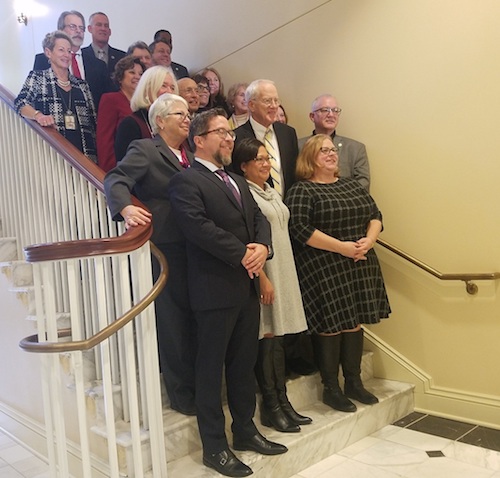 Members and staff of the Commission on Innovation and Excellence in Education pose for a picture on steps inside the House of Delegates in Annapolis on Nov. 21. (William J. Ford/The Washington Informer)