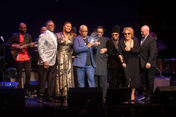 Trumpeter Terence Blanchard (center) receives the 2019 Maria Fisher Founder's Award from Herbie Hancock during the Herbie Hancock Institute of Jazz International Competition finals on Dec. 2. Also onstage is (from left) guitarist Lionel Loueke, actor Keith David, vocalist Lizz Wright, NEA jazz master Dee Dee Bridgewater, jazz vocalist Cassandra Wilson and former New Orleans Mayor Mitch Landrieu. (Shevry Lassiter/The Washington Informer)