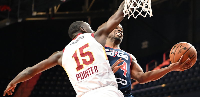 Capital City Go-Go guard Ike Iroegbu attempts a layup against Canton Charge forward Sir'Dominic Pointer during the Go-Go's 113-108 win at the Entertainment and Sports Arena in southeast D.C. on Dec. 7. (John E. De Freitas/The Washington Informer)