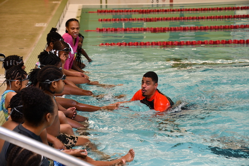 Elementary school students from Aiton Elementary School receive swimming instructions from Cosme Lantigua. (Anthony Tilghman/The Washington Informer)