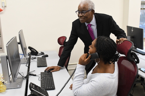 Professor Gary Lynn Harris and graduate student Dana McCalla use Howard University's new Graduate School Research and Media Center after a ribbon-cutting ceremony held on its campus Dec. 9. (Roy Lewis/The Washington Informer)
