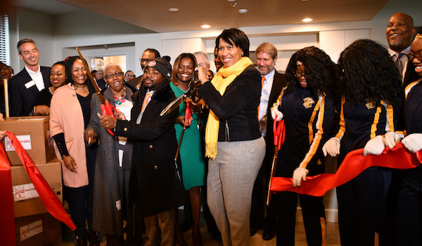 D.C. Mayor Muriel Bowser cuts the ribbon for the Residences at St. Elizabeths East in the Congress Heights neighborhood of Ward 8 on Nov. 23. (Anthony Tilghman/The Washington Informer)