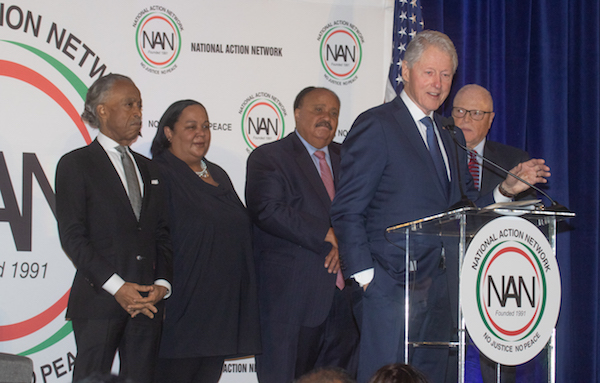 Former President Bill Clinton speaks as (from left) the Rev. Al Sharpton, Tanya Lombard and Martin Luther King III listen during the National Action Network's annual Dr. Martin Luther King Jr. Day Celebration Breakfast at the Mayflower Hotel in D.C. on Jan. 20. (Shevry Lassiter/The Washington Informer)