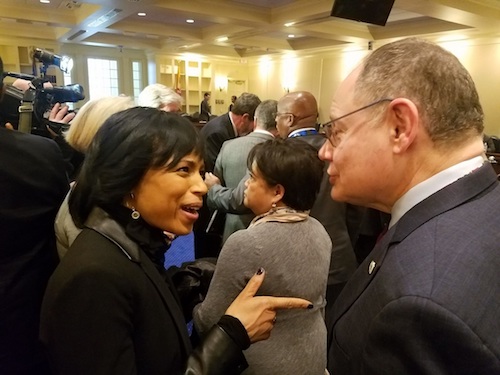 Prince George's County Executive Angela Alsobrooks chats with Montgomery County Council member Sidney A. Katz on Jan. 23 before she testified before the House of Delegates Appropriations Committee in support of a $2.2 billion public school construction bill. (William J. Ford/The Washington Informer)