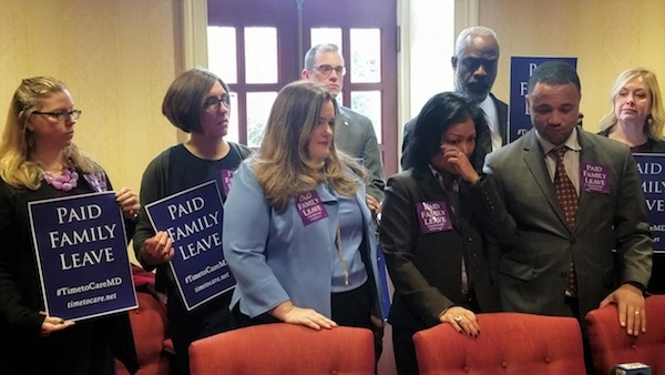 Del. Kris Valderrama (center) dabs her eye while giving emotional remarks Jan. 28 on legislation she will sponsor in the Maryland General Assembly to approve paid family leave for employees. (William J. Ford/The Washington Informer)