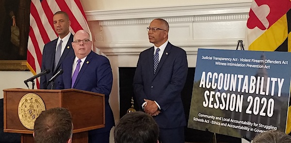 Maryland Gov. Larry Hogan (center) holds a Jan. 7 press conference in Annapolis to introduce proposed legislation focused on accountability. Lt. Gov. Boyd Rutherford (right) and Keiffer Mitchell Jr., Hogan's chief legislative officer, stand alongside the governor. (William J. Ford/The Washington Informer)
