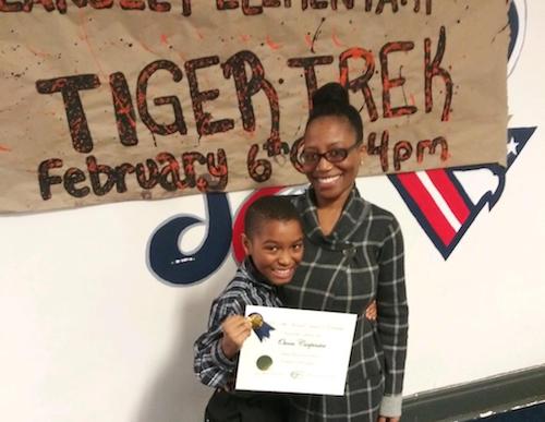 Owen Carpenter, a fifth grader at Hearst Elementary School, standing with his mother Shanta Mays-Carpenter, will be heading to the Washington Informer Charities Spelling Bee in a few weeks. (Courtesy of Ryan Garfield)