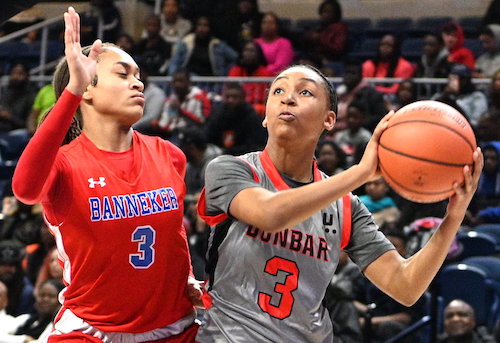 Dunbar guard Zy'aire Hairston looks to shoot over Banneker forward Naki Cobb during Dunbar's 63-35 win in the 2020 DCIAA championship game at the Entertainment and Sports Arena in southeast D.C. on Feb. 16. (John E. De Freitas/The Washington Informer)