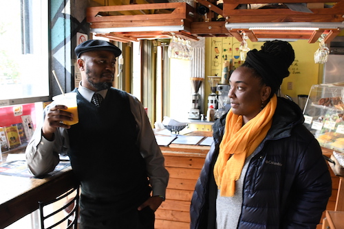 Ward 8 Advisory Neighborhood Commissioner Salim Adofo (left) discusses community issues with Krish Love at Sankofa Café on Feb. 1. (Roy Lewis/The Washington Informer)