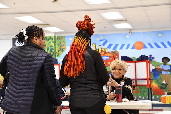 A mother accompanies her daughter who voted for the first time on Super Tuesday at the Charles Drew Community Center in Arlington, Va. (Anthony Tilghman/The Washington Informer)