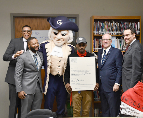 Youth scholar Michael Prather celebrates with city and school officials. (Anthony Tilghman/The Washington Informer)