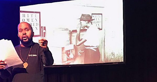 Donney Rose performs excerpts from "The American Audit." (Photo by Josh Hamzehee via NNPA Newswire)