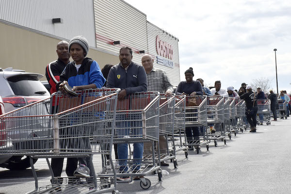 A long line of customers wait to enter a Costco in Maryland's Montgomery County. A letter from Costco’s president indicates they are placing a limit on certain items to ensure access to its members. (Robert R. Roberts/The Washington Informer)