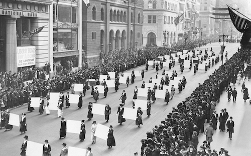 Women's suffragists parade in New York City in 1917, carrying placards with the signatures of more than a million women (The New York Times Photo Archive via Wikimedia Commons)