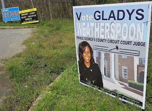 A yard sign for Gladys Weatherspoon, a candidate for Prince George's County Circuit Court judge, along Route 202 near White House Road in Upper Marlboro is shown here on April 5. The sign with black background in the center shows the five incumbent judges running as a slate. (William J. Ford/The Washington Informer)