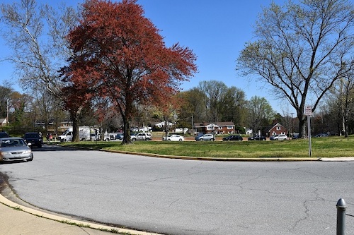 Vehicles line up outside Crossland High School in Temple Hills on April 2 to obtain a Google Chromebook for students to use for distance and online learning during the coronavirus pandemic. (Anthony Tilghman/The Washington Informer)