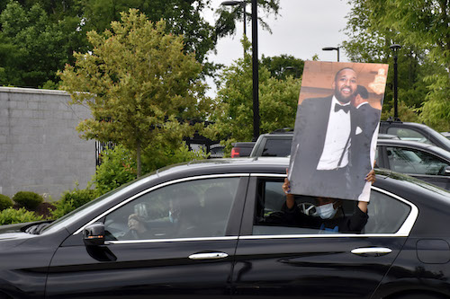 A protester holds out a photo of Finan Berhe, killed May 7 in White Oak by Sgt. David Cohen, a member of the Montgomery County Police Department. (Robert R. Roberts/The Washington Informer)