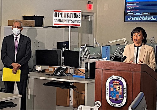 Prince George's County Executive Angela Alsbrooks speaks during a May 14 press conference to announce the extension of the countywide stay-at-home order through June 1 amid the coronavirus pandemic as Ernest Carter, the county's chief health officer, listens. (William J. Ford/The Washington Informer)