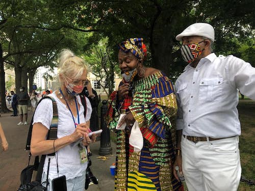Monique Stringer-Olomidun (center) and Risegun Olomidun (right) speak to a reporter about defunding the police at a spiritual healing restoration circle in D.C. on June 12. (Courtesy of Monique Stringer-Olomidun via Facebook)