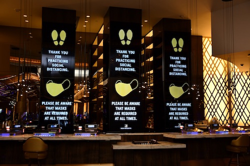 Huge signs at the MGM National Harbor remind patrons of its requirements for masks and social distancing as the casino resort reopens amid the coronavirus pandemic. (Anthony Tilghman/The Washington Informer)
