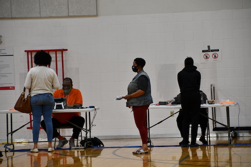 Citizens await to vote at the Southern Regional Technology and Recreation Complex in Fort Washington on June 2, as election workers sit behind plexiglass for protection. (Anthony Tilghman/The Washington Informer)