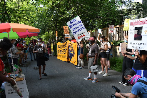 Protesters march in Takoma Park on July 10 to condemn construction of a storage facility on the Moses African Cemetery in Bethesda. (Roy Lewis/The Washington Informer)
