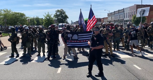In a screen grab of a video posted by the Richmond Times-Dispatch, demonstrators protesting for gun rights march outside the Science Museum of Virginia in Richmond as state lawmakers hold a special session of the General Assembly on Aug. 18.
