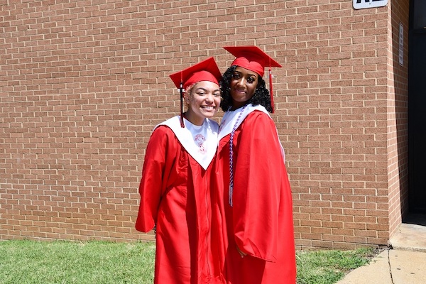 Daija Jeter (left) and Kristina Crawford pose after a diploma ceremony outside Suitland High School on Aug. 5. Both will attend historically Black institutions — Crawford at Bowie State University and Jeter at Morgan State University in Baltimore. (Anthony Tilghman/The Washington Informer)