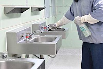 An incarcerated individual cleans a sink. (Courtesy of Maryland Department of Public Safety and Correction Services)
