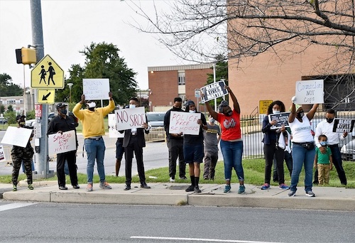 Protesters hold signs during a Sept. 15 rally outside Suitland High School in Forestville, Maryland, against school resource officers in Prince George's County schools. (Anthony Tilghman/The Washington Informer)