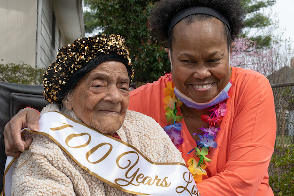 Virginia Ada Hawkins Keane, who celebrated her 101st birthday Saturday, March 24, poses for a photo with her daughter Karen. Neighbors, friends and family gathered for a drive-by celebration at her home in Northwest. (Shevry Lassiter/The Washington Informer)