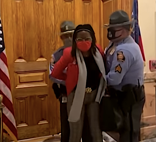 Georgia state troopers arrest Democratic state Rep. Park Cannon in the state capitol on March 25 as Republican Gov. Brian Kemp signed a law enacting broad voting restrictions that activists say target Black voters.