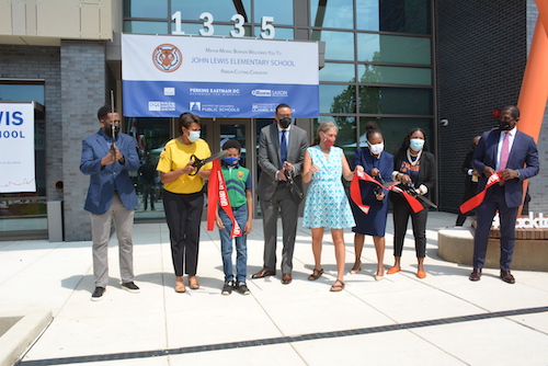 From left: Department of General Services Director Keith Anderson, D.C. Mayor Muriel Bowser, West Education Campus student Henry Levenstein, D.C. Public Schools Chancellor Lewis Ferebee, ANC Commissioner Maria Barry (SMD 4C02), D.C. Council member Janeese Lewis George (D-Ward 4), West Education Campus Principal Lakeysha Jackson and late Rep. John Lewis’s chief of staff Michael Collins cut the ribbon for the newly constructed school. (Roy Lewis/The Washington Informer) 