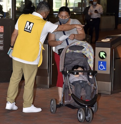 A Metro employee helps a rider at Prince George's Plaza Metro station in Hyattsville, which reopened Sept. 7 after nearly an entire summer of platform work and other safety improvements. (Robert R. Roberts/The Washington Informer)