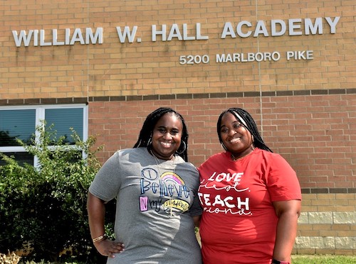 Elementary school teachers and sisters Theresa Wood (left) and Maria Wood stand outside William W. Hall Academy in Capitol Heights. (Robert R. Roberts/The Washington Informer)