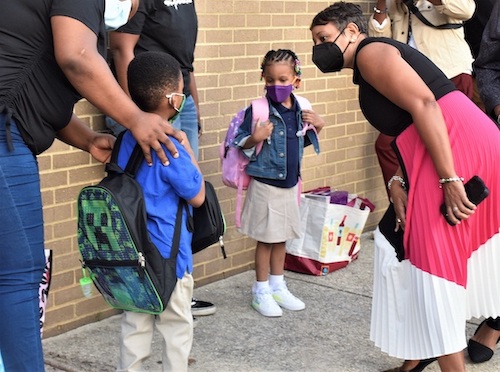 Prince George's County Public Schools CEO Monica Goldson (right) chats with a student outside Deerfield Run Elementary in Laurel on Sept. 8, the county's first day of school. (Robert R. Roberts/The Washington Informer)