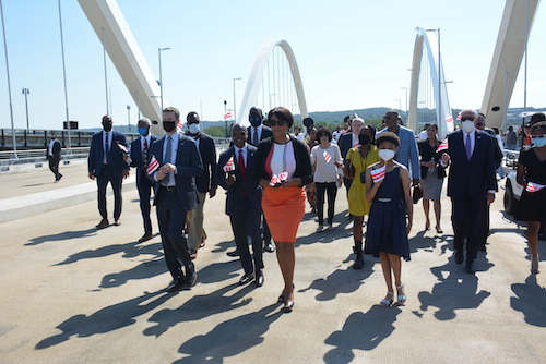 D.C. Mayor Muriel Bowser with Ward 6 Council member Charles Allen and city officials and supporters walk across the newly opened Frederick Douglass Bridge as they prepared for the ribbon-cutting on Sept. 7. (Roy Lewis/The Washington Informer)