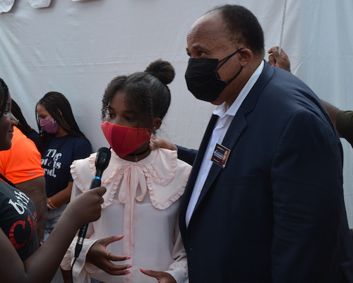 Martin Luther King III looks on as his daughter, Yolanda 13 is interviewed at the March for Voting Rights on Aug. 28 in D.C. (Roy Lewis/The Washington Informer)