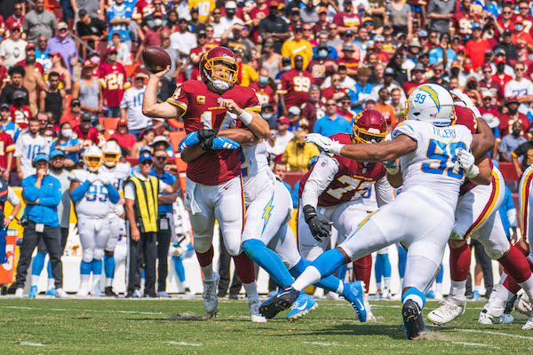 Washington Football Team quarterback Ryan Fitzpatrick is sacked during a 20-16 home loss to the Los Angeles Chargers at FedEx Field, in Landover, Md., on Sept. 12, 2021. (Abdullah Konte/The Washington Informer)